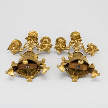 A table CLOCK and a pair of candelabra, second part of 19th century.