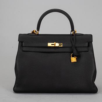HERMÈS, a 'Kelly 35' black leather bag.