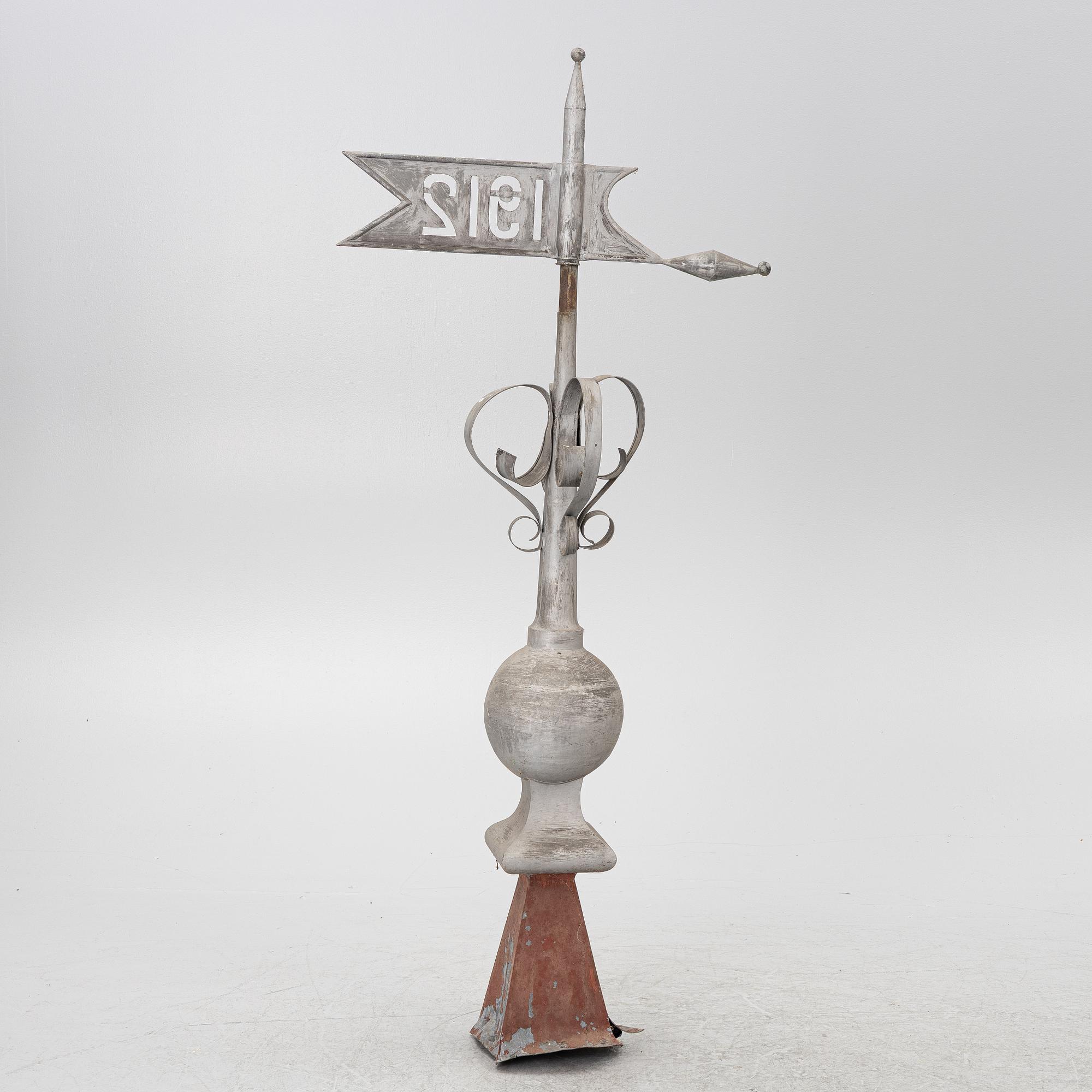 Tower spire with weather vane dated 1912.