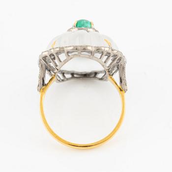 Ring with cut rock crystal, diamonds, and cabochon-cut emerald.
