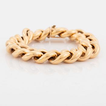 An 18K gold bracelet.