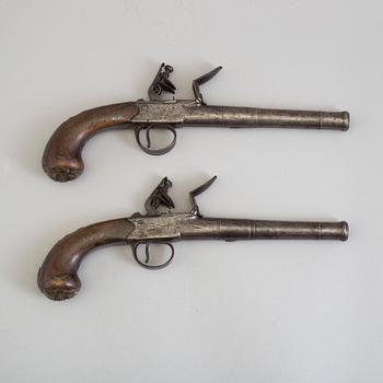 A pair of Queen Anne flintlock pistols makers mark Barker and London proof marks.