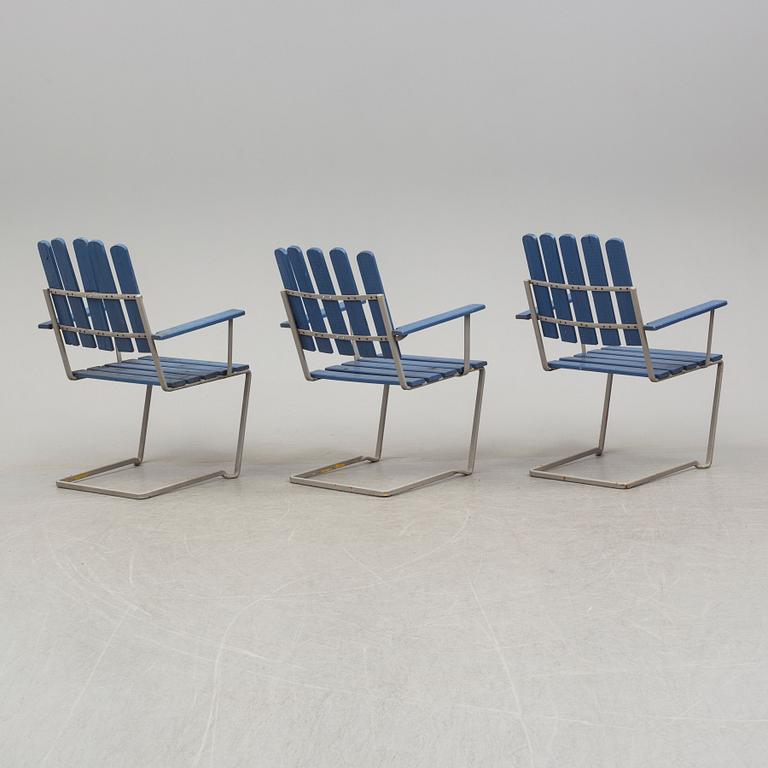 A painted garden table and four armchairs, first half of the 20th century.