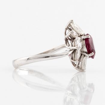 A ring set with a faceted ruby and navette-cut diamonds.