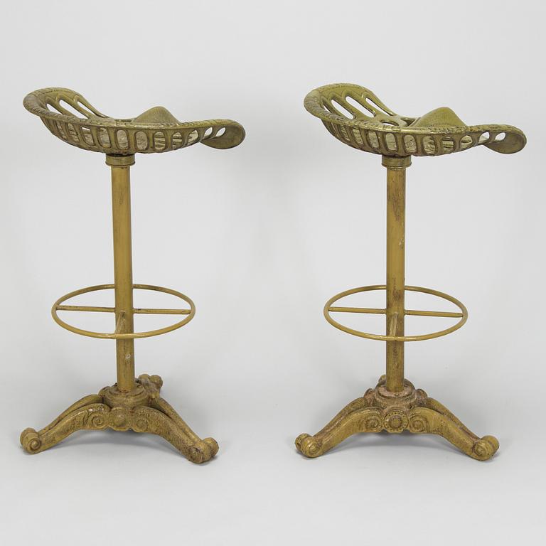 Four bar stools, painted cast iron, partly from the early 20th century.