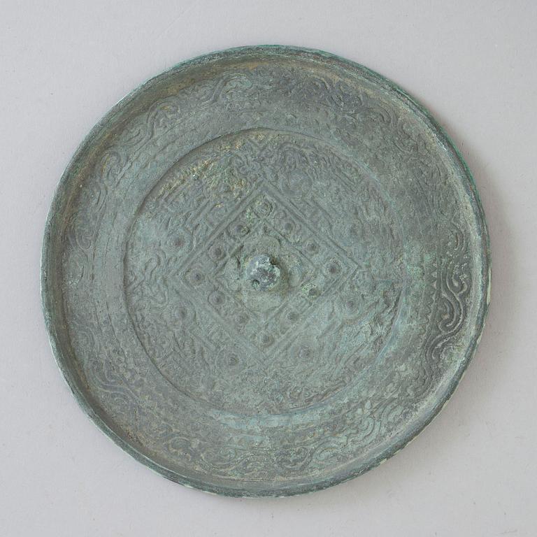 A bronze mirror, Xin-Eastern Han dynasty (9-220).
