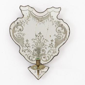 A North European rococo one-branch engraved glass girandole mirror, mid 18th century.