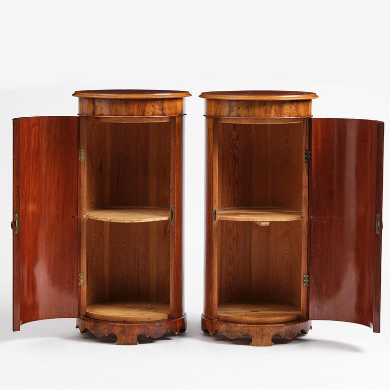 A pair of late Empire mahogany column cabinets, mid 19th Century.