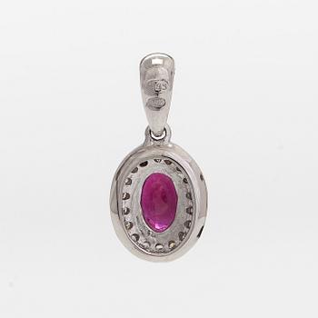 A 14K white gold pendant, with an oval faceted ruby and diamonds.