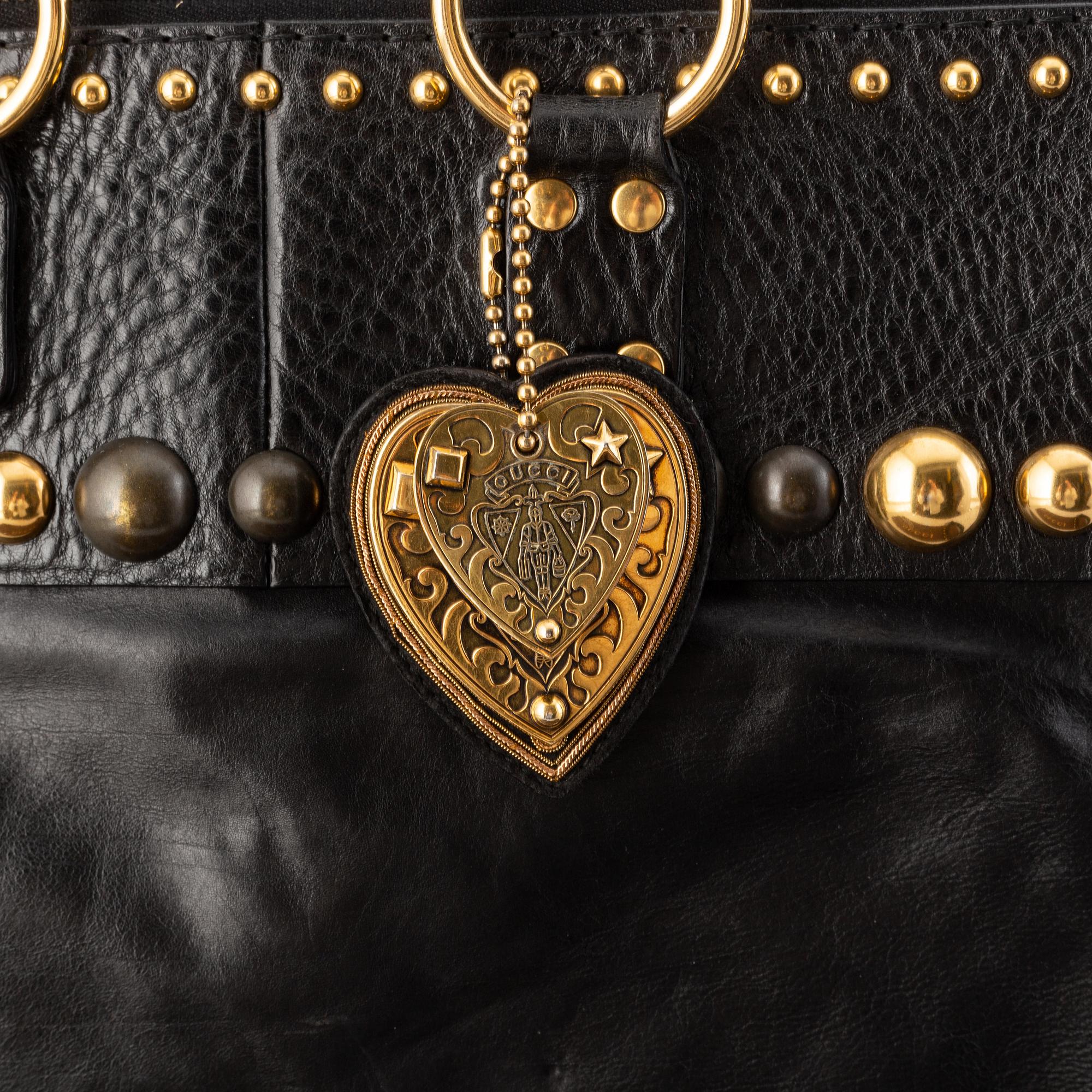 Gucci, a black leather handbag.