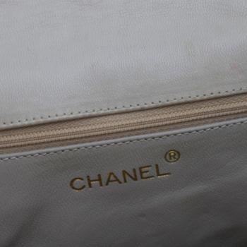CHANEL, a beige shoulder bag.