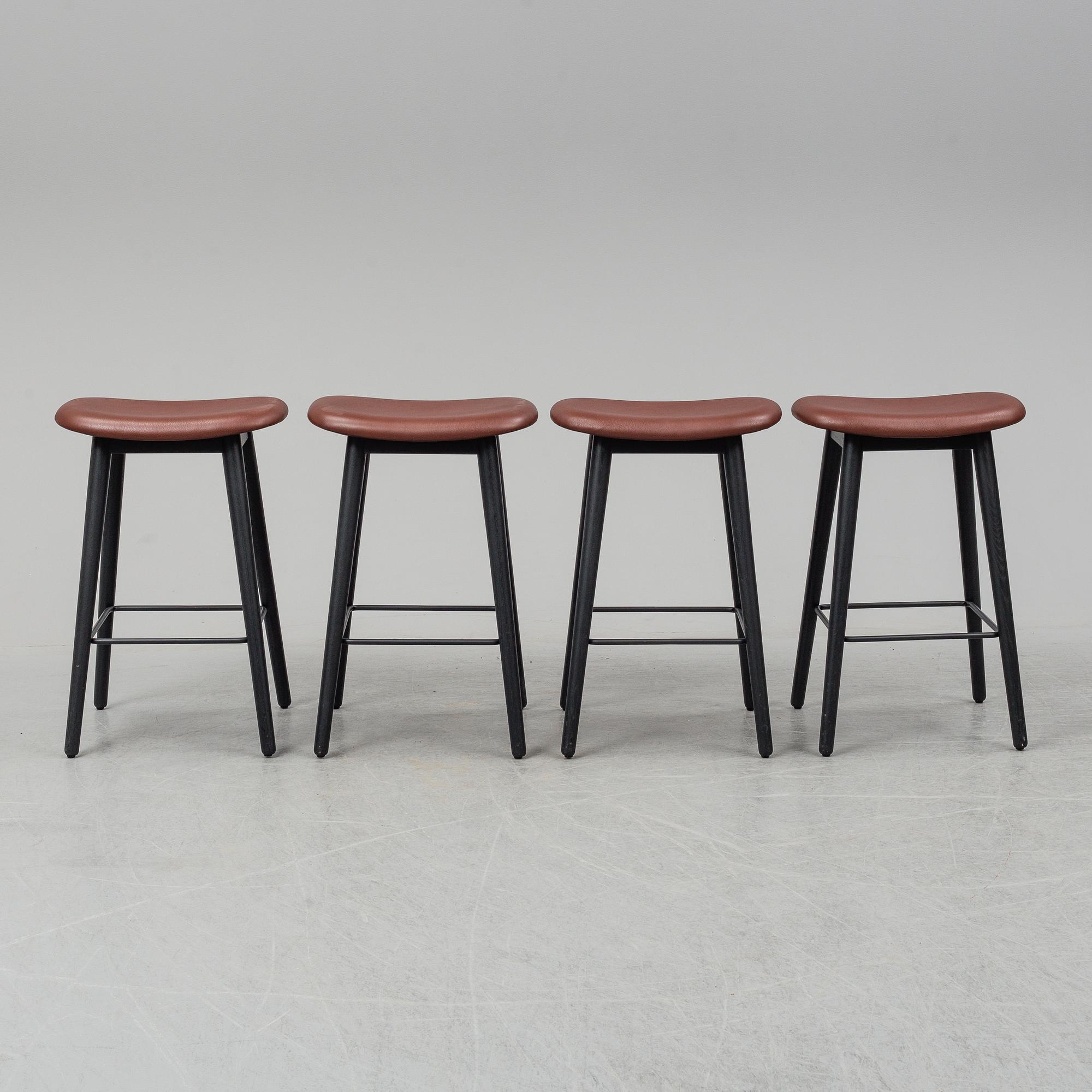 Four contemporary leather upholstred stools by Berlin & Iskos for Muuto.