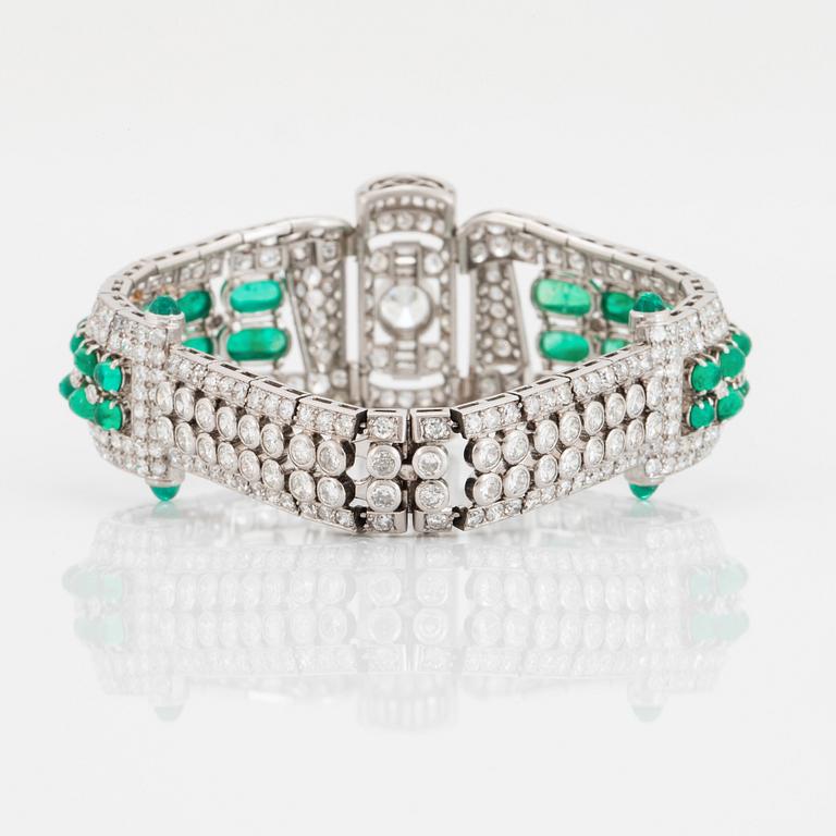 A platinum bracelet set with cabochon-cut emeralds and old-, eight- and baguette-cut diamonds.