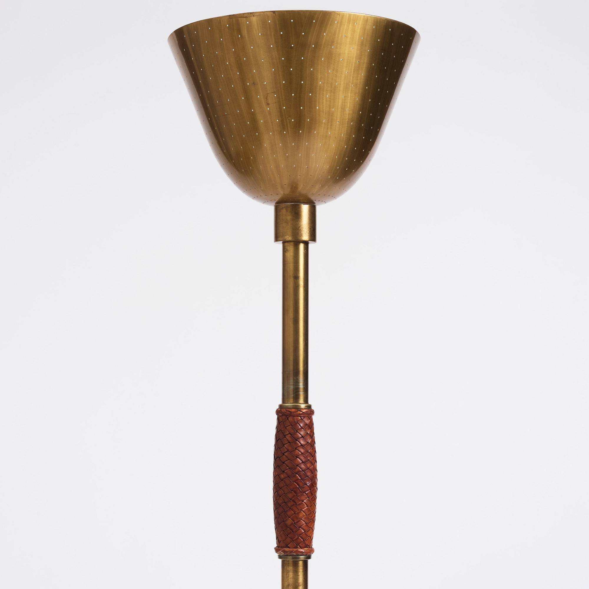 Carl-Axel Acking, a brass and leather floor lamp, designed for the Stockholm Association of Crafts in 1939.