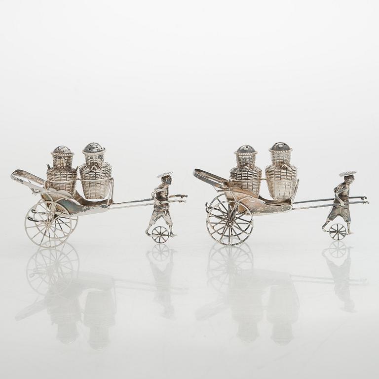 Four shakers in a pair of miniature rickshaws, sterling silver, maker's mark of Wai Kee, Hong Kong.