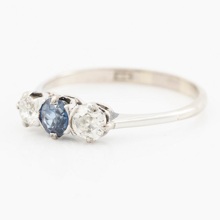 18K gold ring with two old-cut diamonds and a blue stone.
