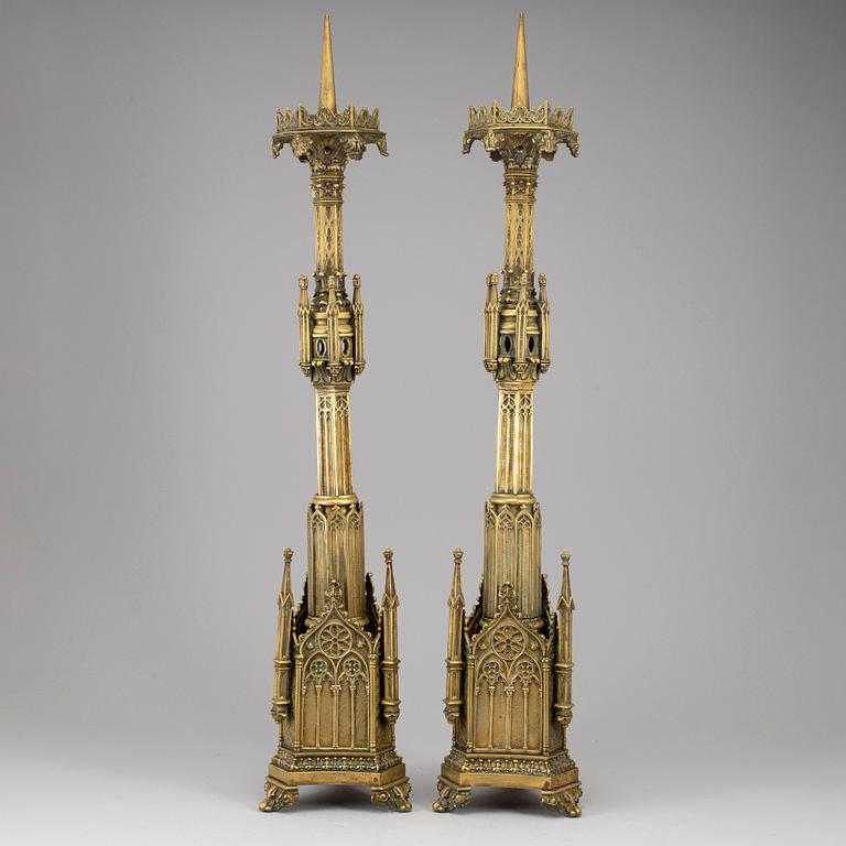 A pair of Pugin style gothic revival candlesticks, mid 19th century.