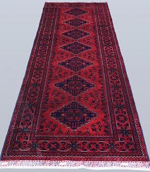 An Afghan runner, approximately 283 x 87 cm.