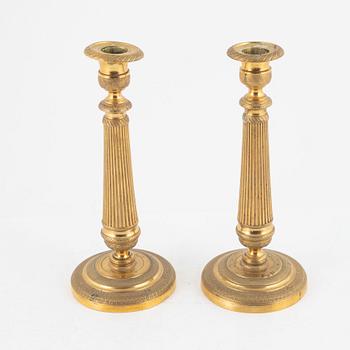 A pair of gilt brass Empire candlesticks, early 19th century.