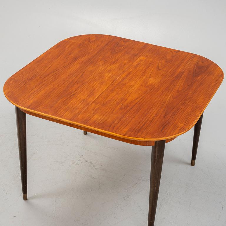 A teak-veneered dining table, mid 20th century.