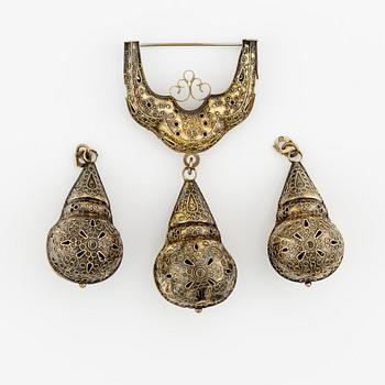 A brooch and two pendants, silver.