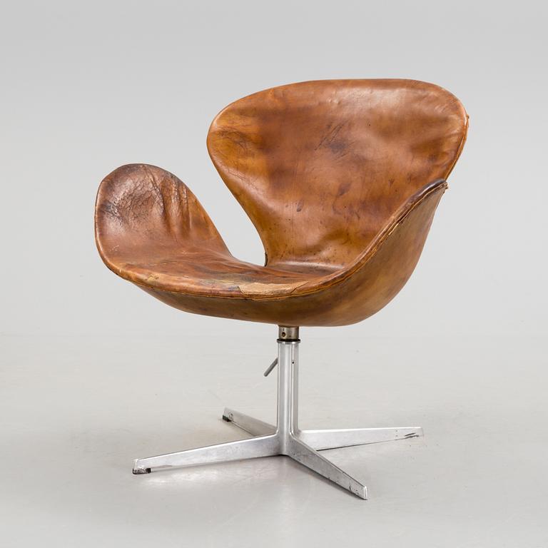 An Arne Jacobsen steel and brown leather 'Swan' chair, Fritz Hansen, Denmark 1960's.