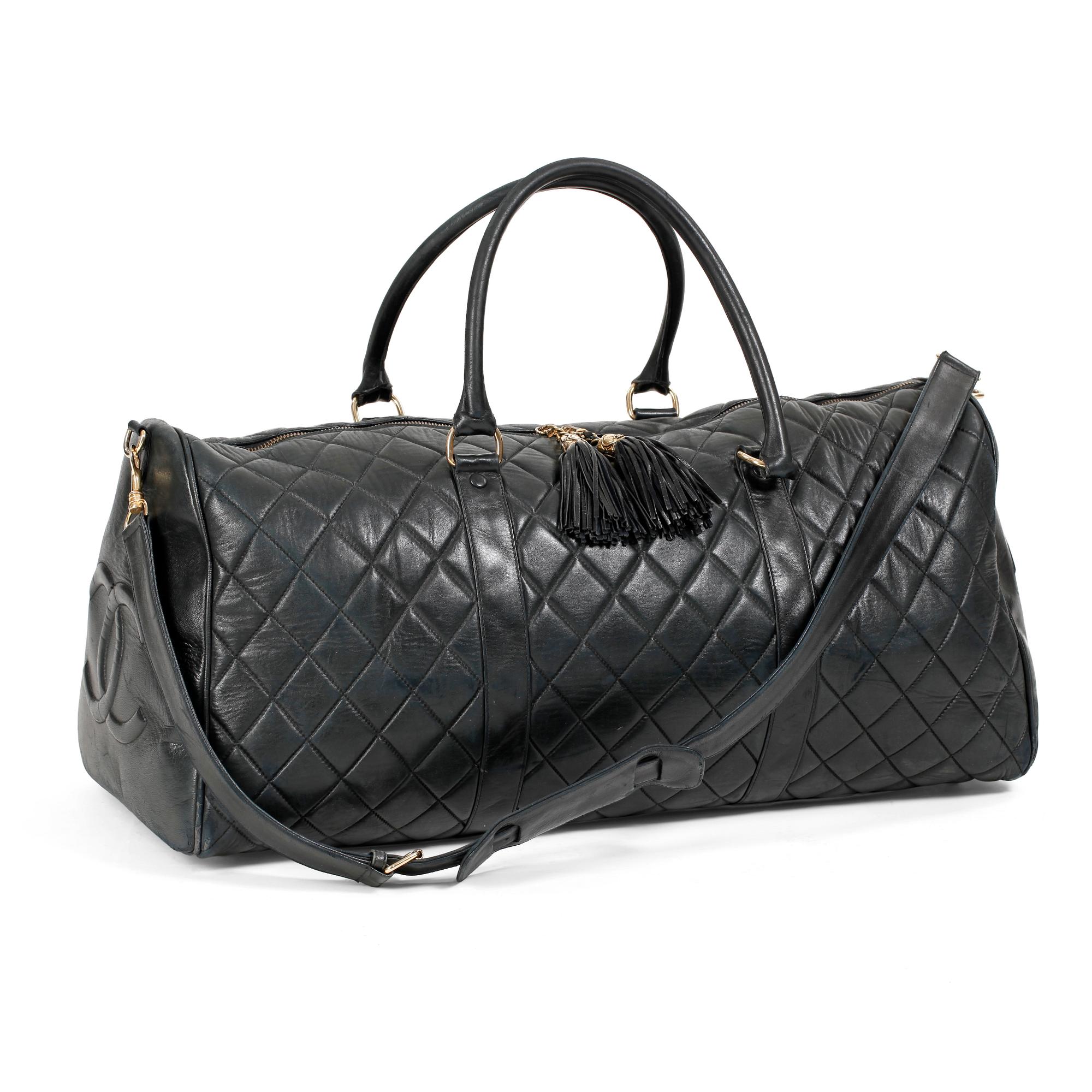 CHANEL, a black leather weekend bag.