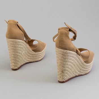 A beige suede platform sandals by Hermès.