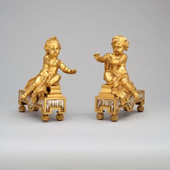 A pair of French 19th century gilt and silvered bronze chenets.