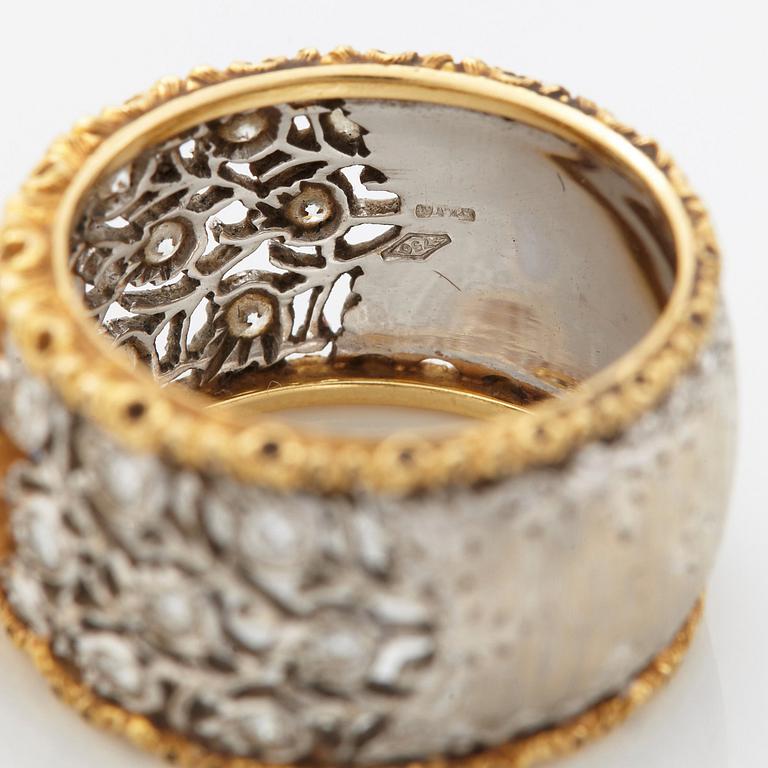 A Buccellati ring in 18K gold and white gold set with a faceted sapphire and round brilliant-cut diamonds.