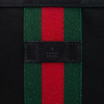 Gucci, a "Techno Canvas Web Messenger" bag.