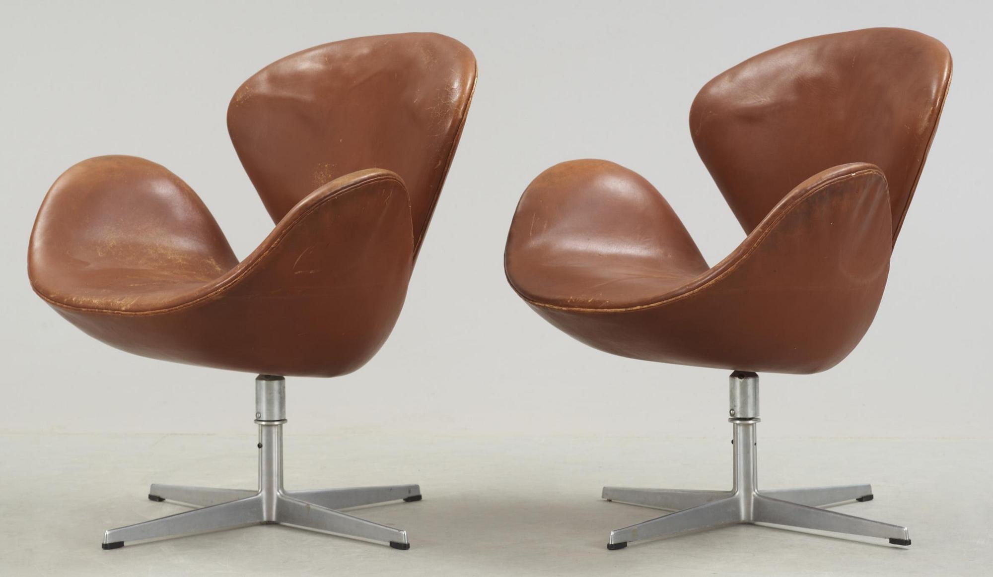 A pair of Arne Jacobsen brown leather 'Swan' chairs, Fritz Hansen, Denmark 1972.