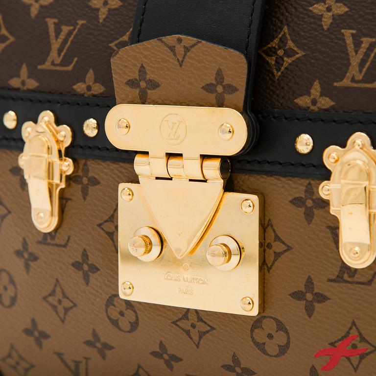 Louis Vuitton, a "Reverse Monogram Trunk Clutch" bag.