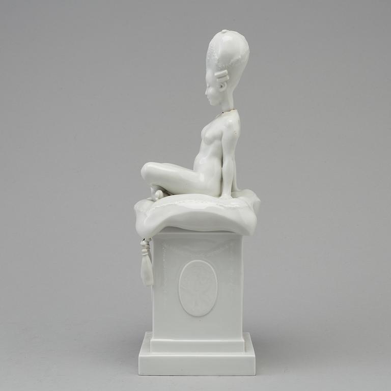 A white glazed Royal Copenhagen porcelain nodding head figure, Denmark, early 20th Century. Not first quality.