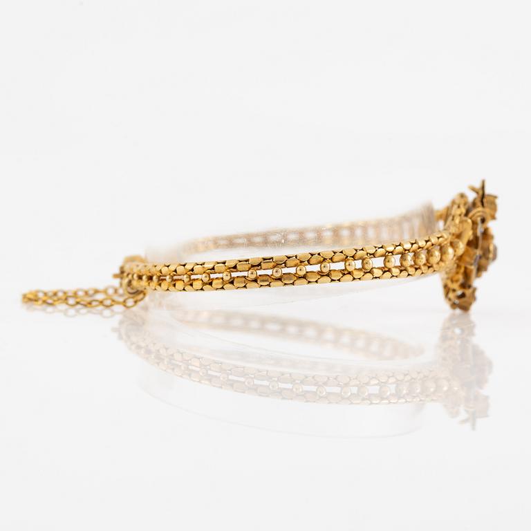 Bracelet, gilded metal with paste stones and enamel.