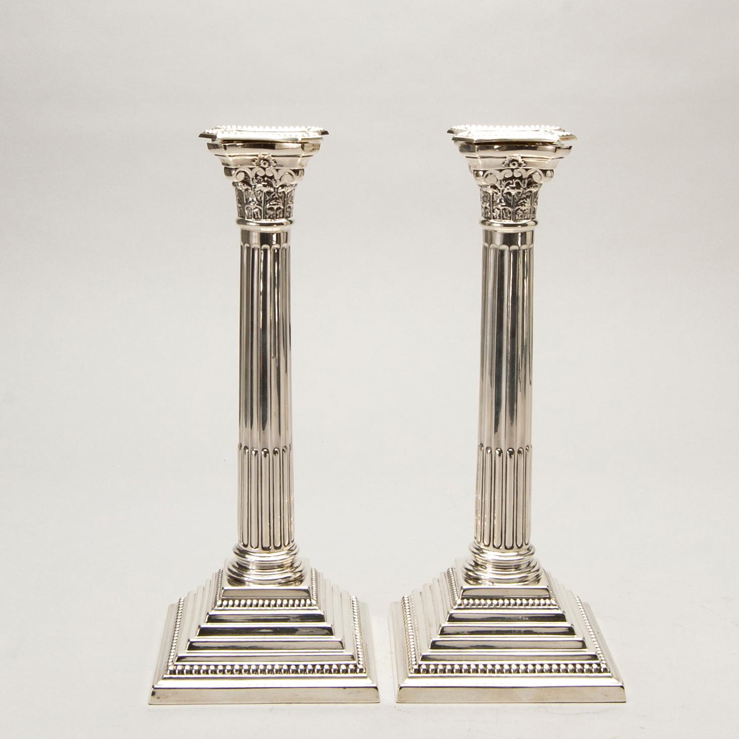 A pair of classical column sterling silver candlesticks Birmingham, 1934, by 'B.G. & Co'.