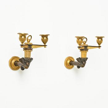 A pair of Empire patinated and ormolu two-branch appliques attr. to C. Galle (bronzier in Paris 1786-1815).