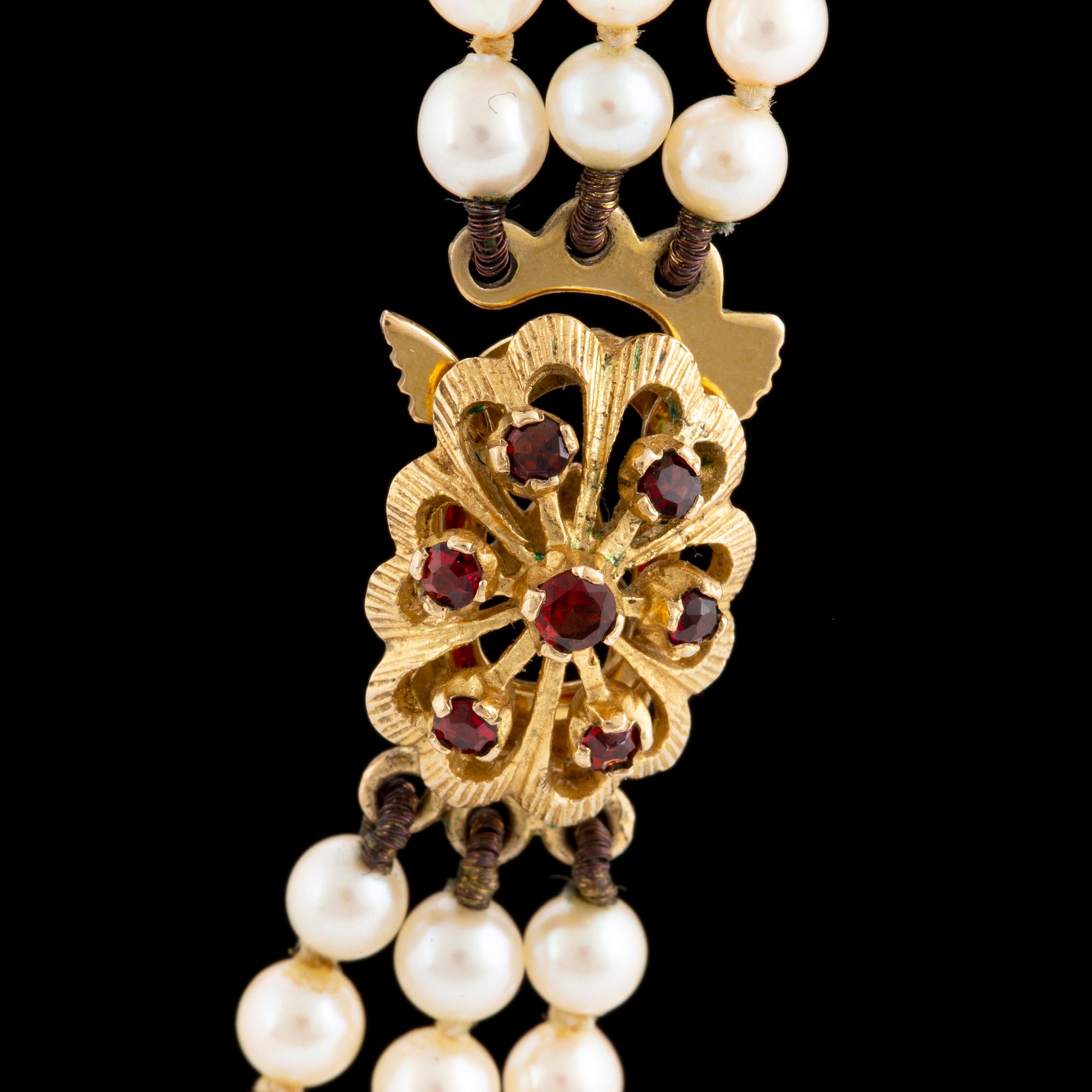 A three strand cultured pearl necklace.