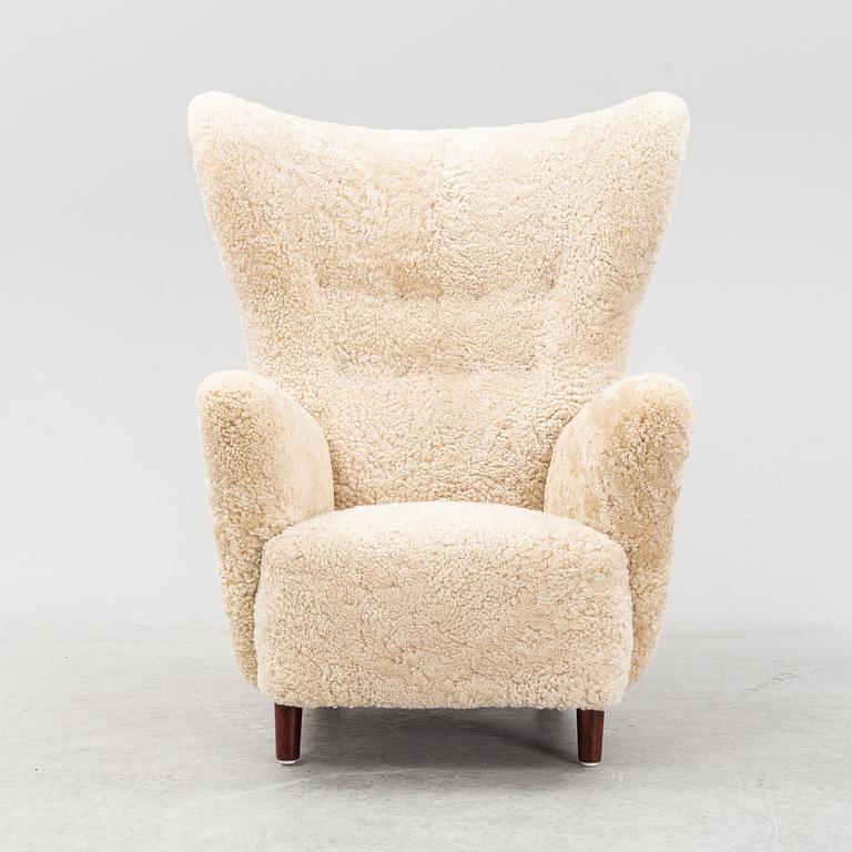 A sheepskin upholstered wing back lounge chair, 1940s.