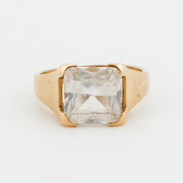 A synthetic white spinel, 18K gold.