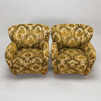 A pair of 1950s armchairs.