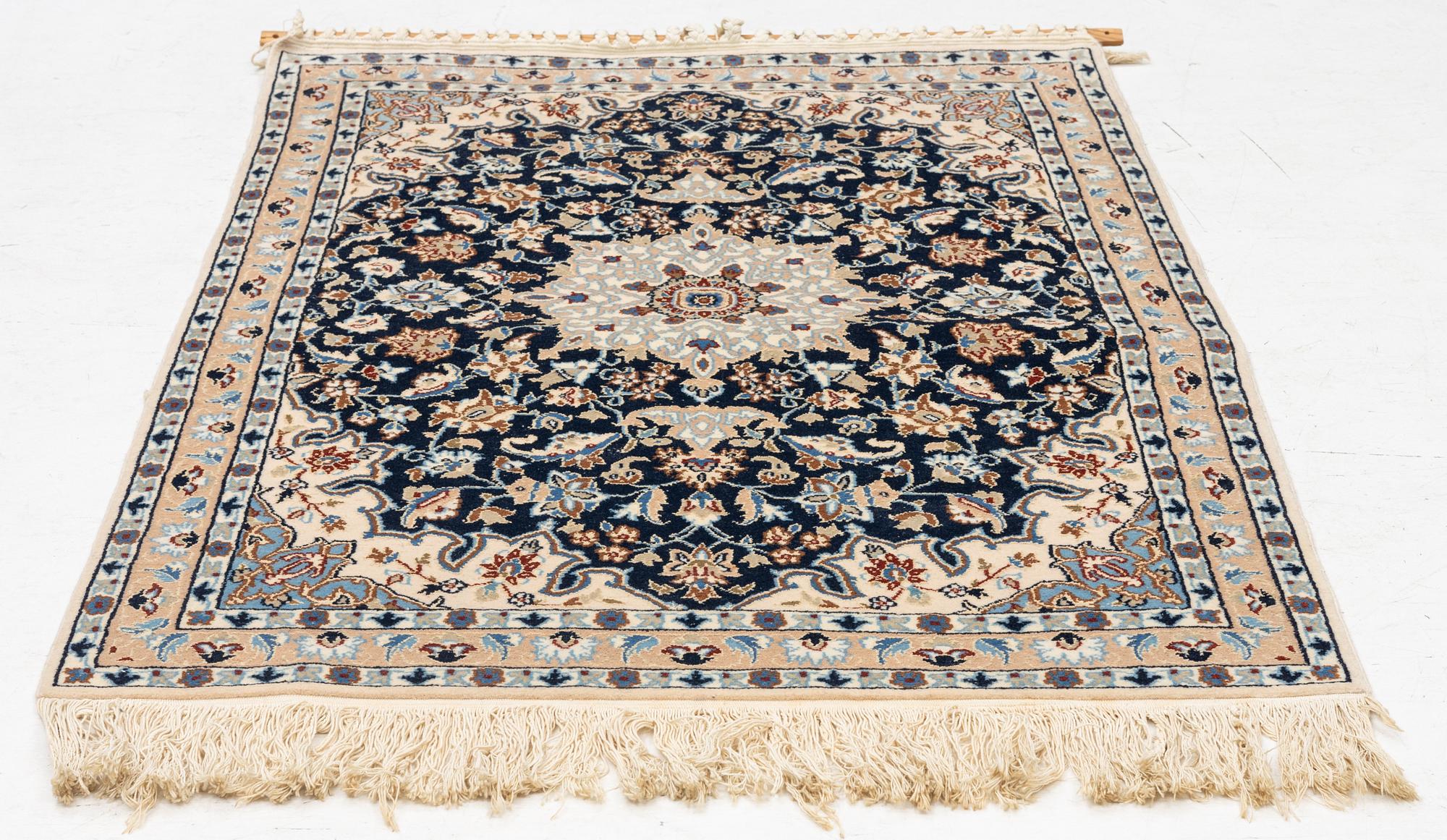 A Nain rug, part silk, c. 128 x 82 cm.