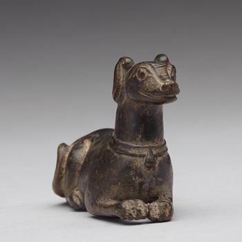 A bronze figure of a reclining dog, Ming dynasty (1368-1644).