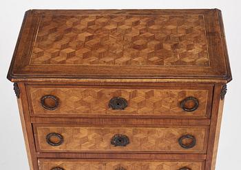 A Louis XVI-style parquetry commode, circa 1900.
