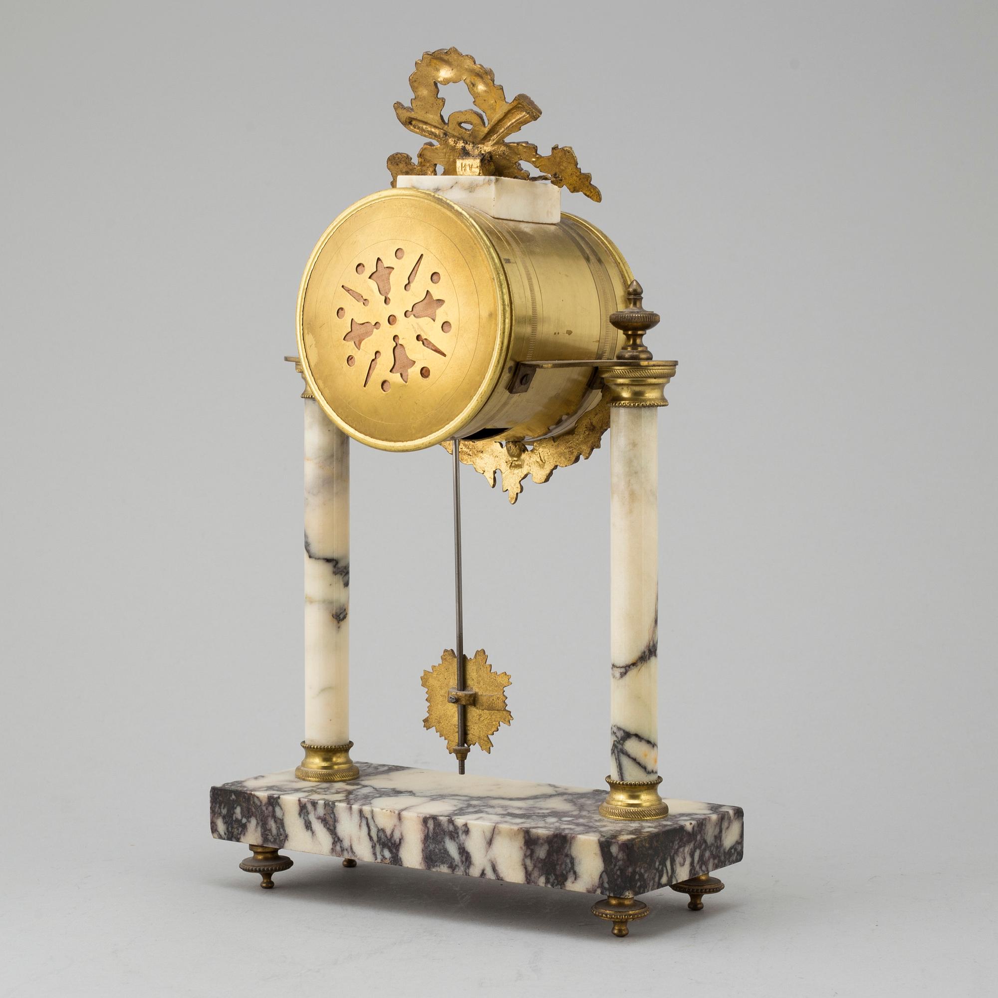 A marble and brass pendulum clock, first half of the 20th century.