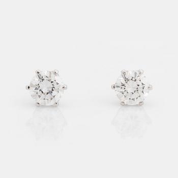 471. A pair of 18K white gold earrings set with two round brilliant-cut diamonds.