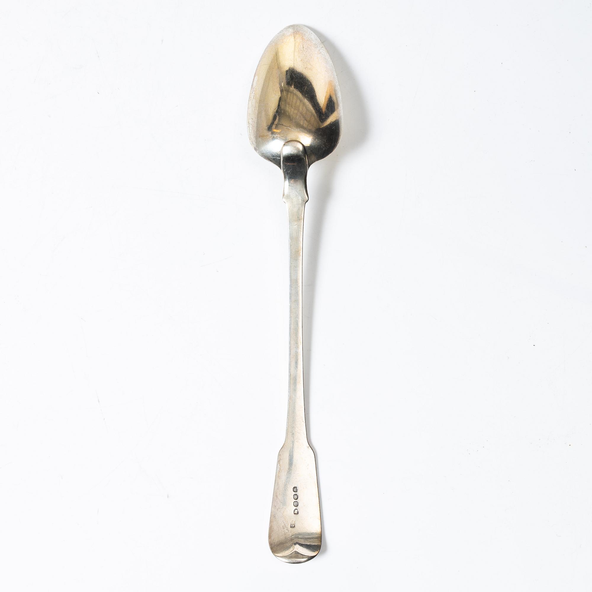 An English silver serving spoon, London 1815.
