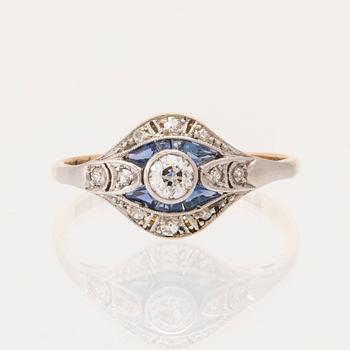 An 18K white and red gold ring set with old-cut diamonds and step-cut blue gemstones, Petterssons Stockholm 1937.