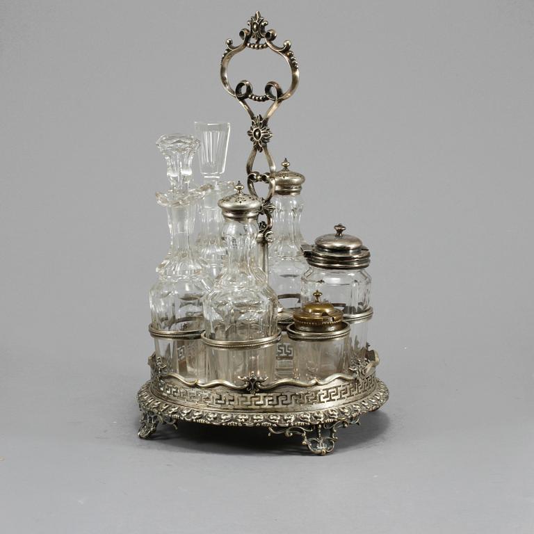 BORDSSURTOUT, 7 delar, vitmetall och glas, omkring år 1900.