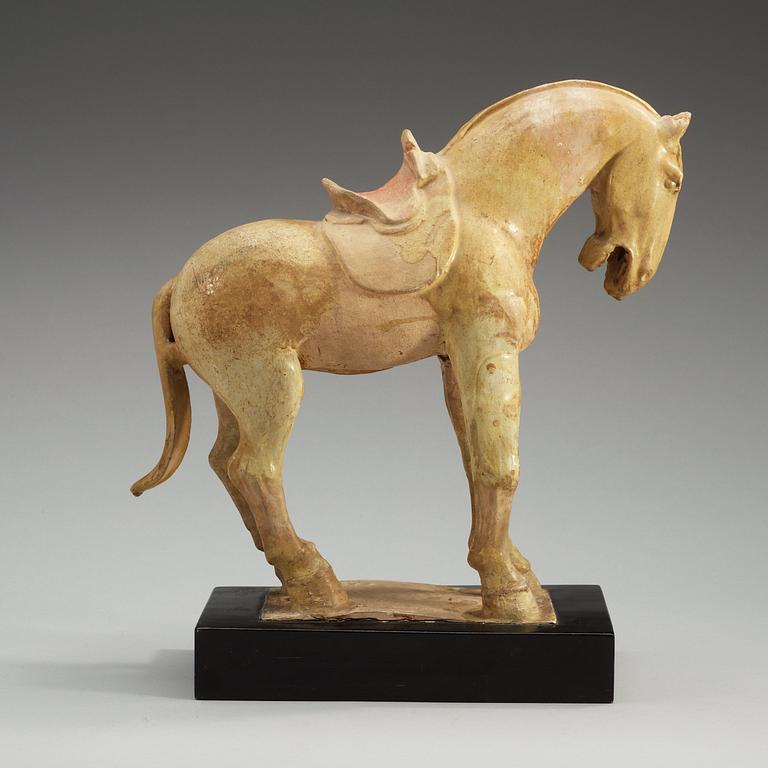 A yellow glazed pottery figure of a horze, presumably Tang dynasty (618-907).